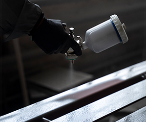 Binder application in industrial spray for structural integrity in coatings